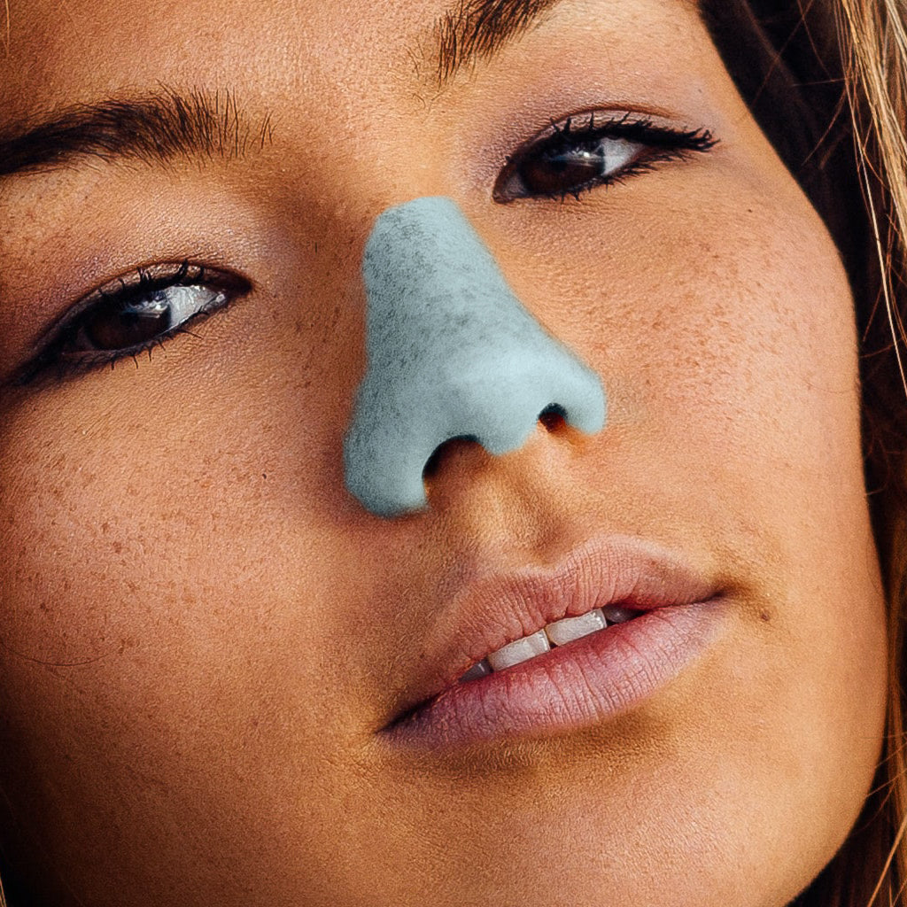 Woman applies Nöz, the best SPF, to her nose before going out. 